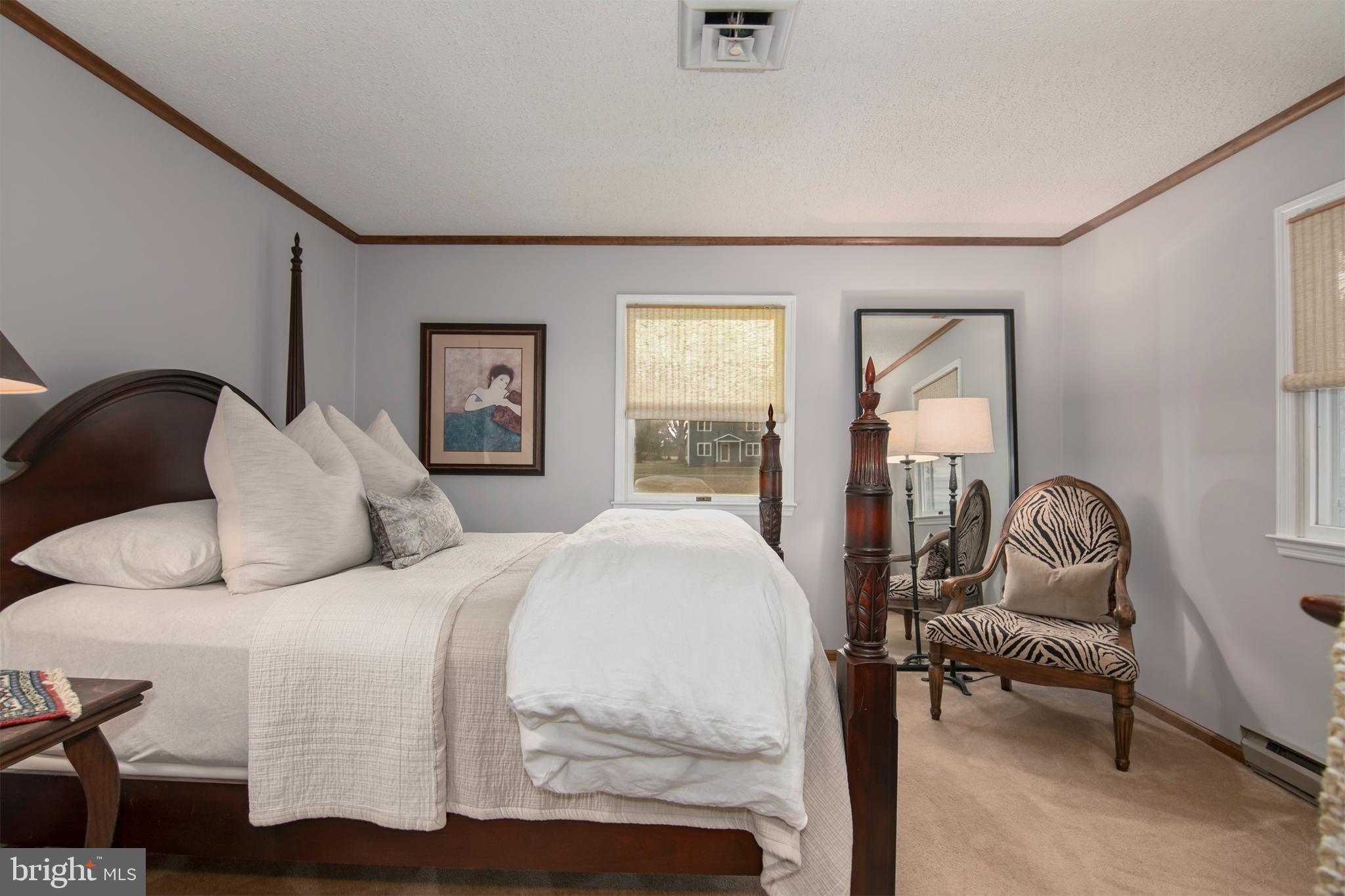 5529 Whitehall Road Cambridge, MD 21613 - Photo 30 of 41 a bedroom with a bed and wooden floor