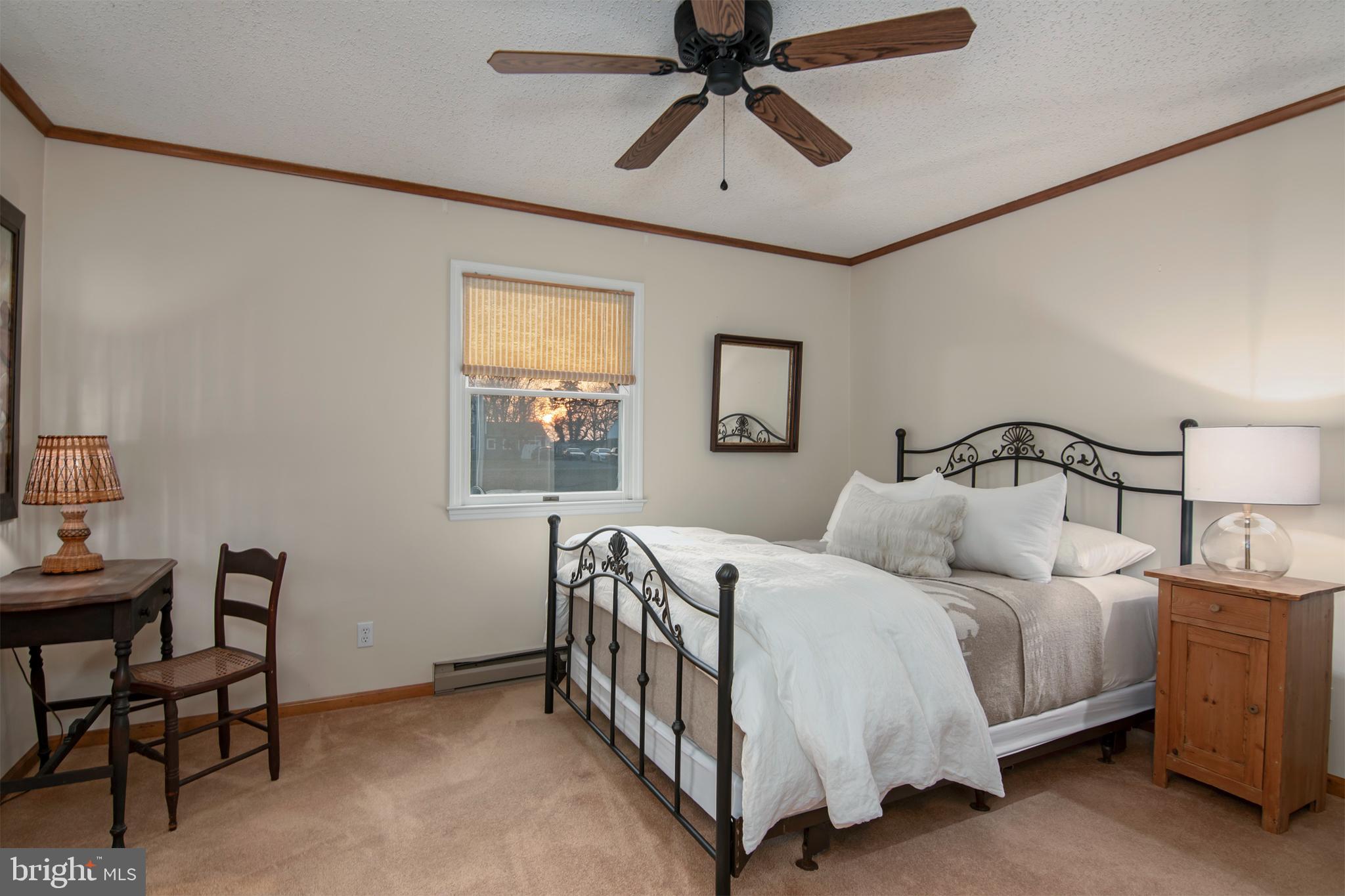 5529 Whitehall Road Cambridge, MD 21613 - Photo 31 of 41 a bedroom with a bed and a chandelier