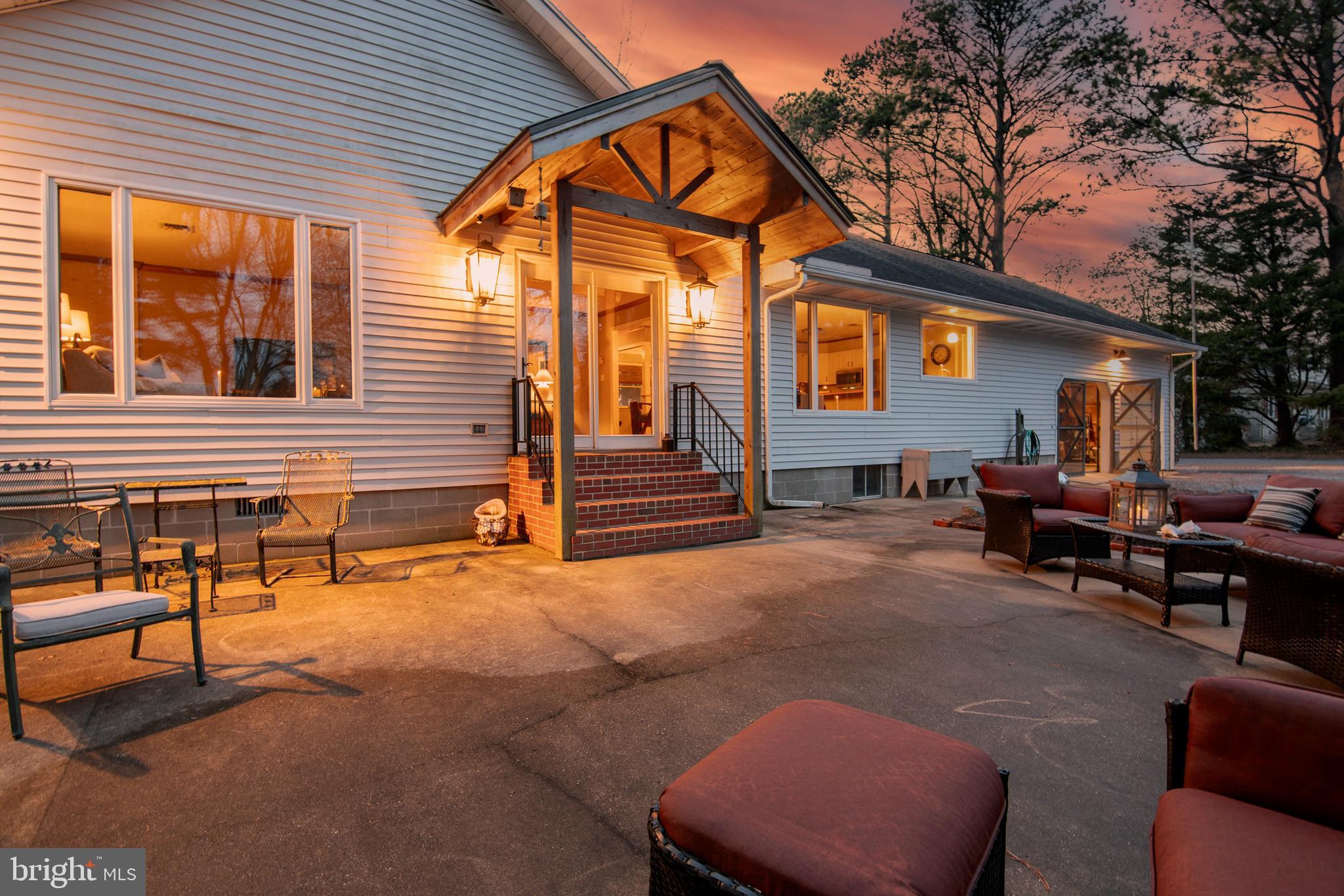 5529 Whitehall Road Cambridge, MD 21613 - Photo 4 of 41 a backyard of a house with barbeque oven table and chairs