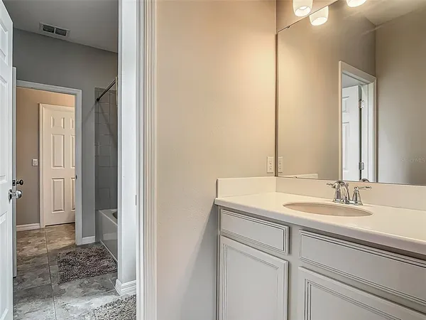 a bathroom with a sink and a mirror