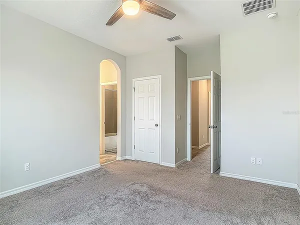 an empty room with window and bathroom