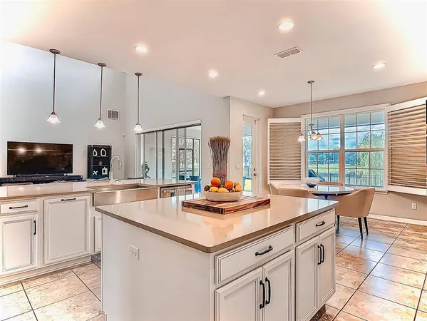 a kitchen with a sink and white cabinets
