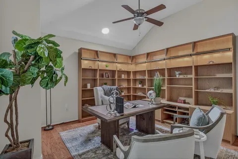 a work room with furniture and a potted plant