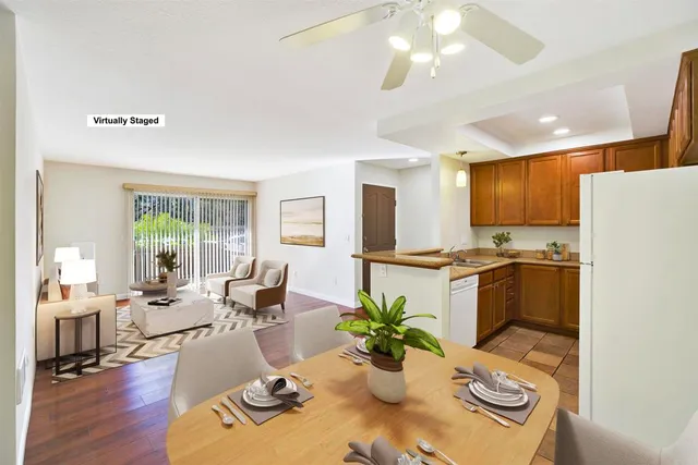 a living room with furniture kitchen and a large window
