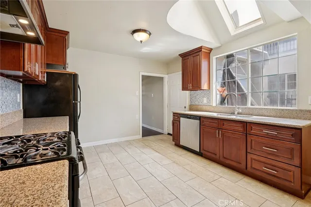 a kitchen with stainless steel appliances granite countertop a stove and a sink