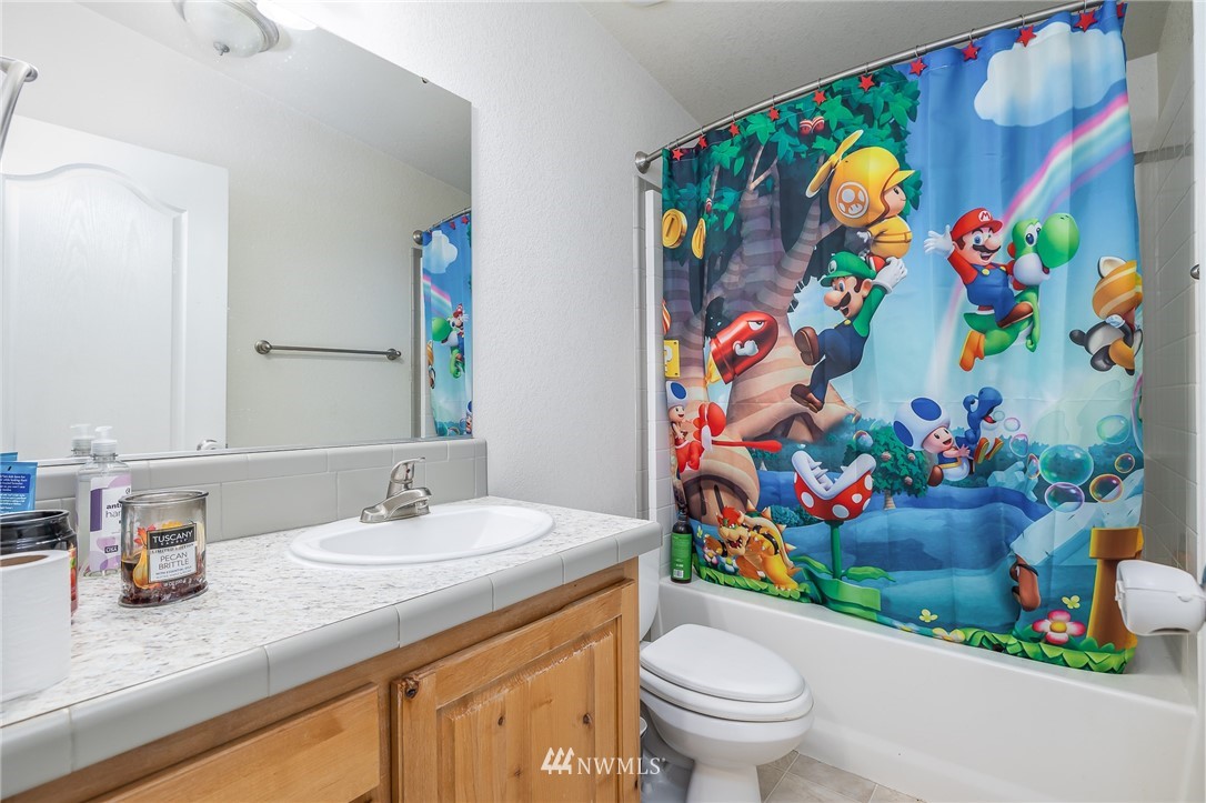 33408 South Haney Road Kennewick, WA 99337 - Photo 14 of 28 a bathroom with a granite countertop sink and a mirror