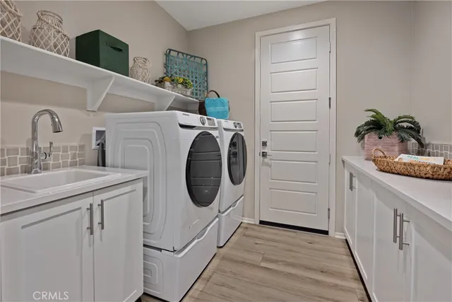 a utility room with sink dryer and washer
