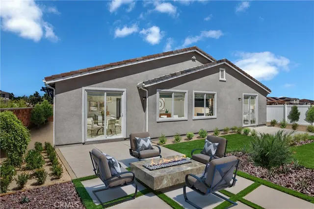 a view of backyard of house with seating space