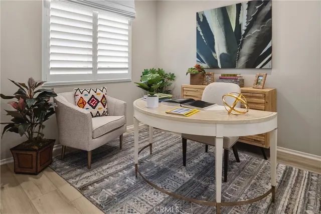 a view of a workspace with furniture and a potted plant