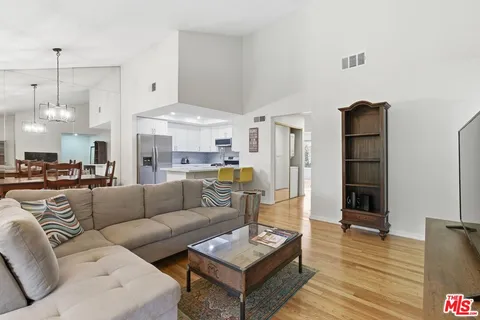 a living room with furniture and a chandelier