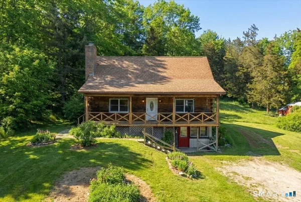 a view of a house with swimming pool and sitting area