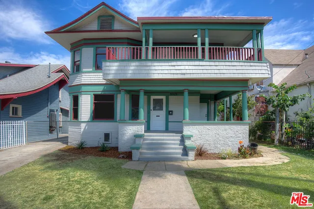 a front view of a house with a yard table and chairs