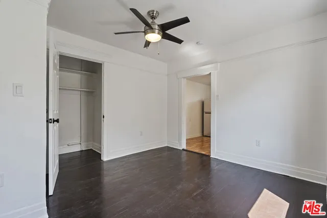 a kitchen with a refrigerator and a stove top oven