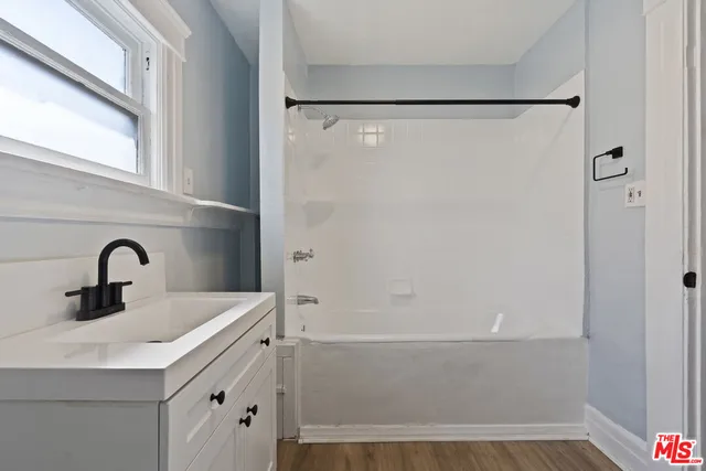 a bathroom with a sink and shower