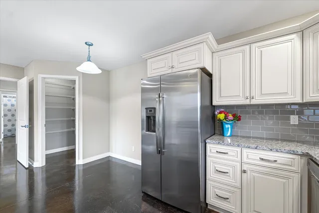 a kitchen with stainless steel appliances a refrigerator sink and cabinets