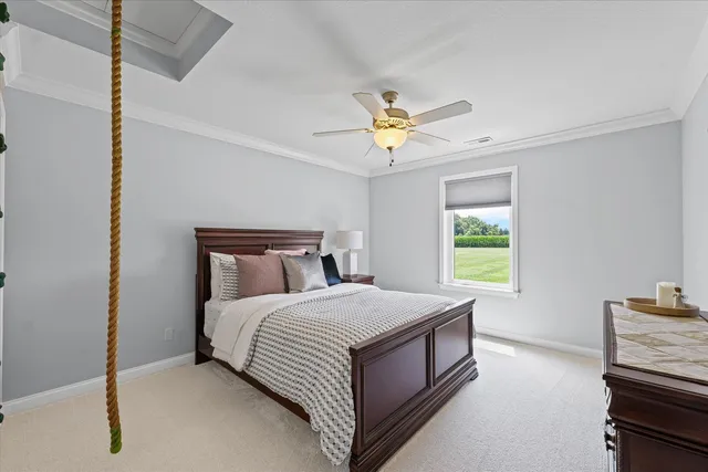 a bedroom with a bed and a chandelier