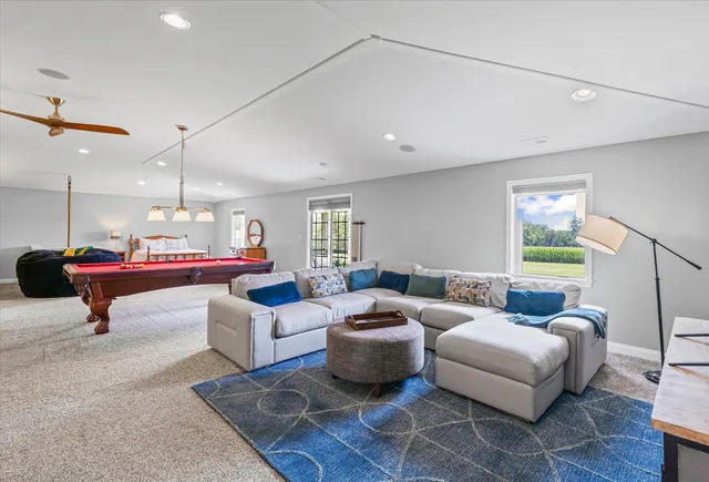a living room with furniture a rug and a window