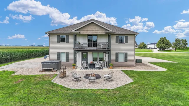 a view of a house with backyard and sitting area