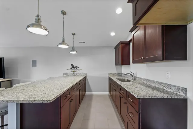a kitchen with two sink a stove and cabinets