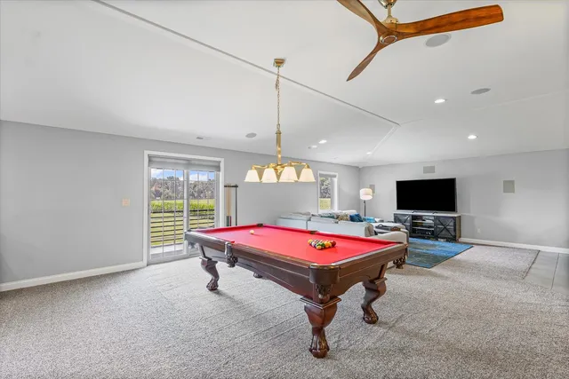 a room with pool table and flat screen tv