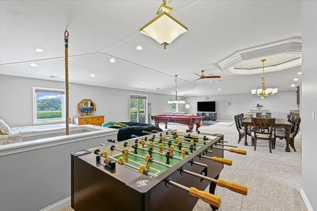 a living room with lots of furniture and a large window