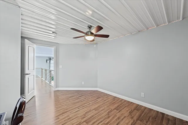 a view of a livingroom with a hardwood floor and a ceiling fan