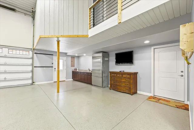 a view of an empty room and kitchen