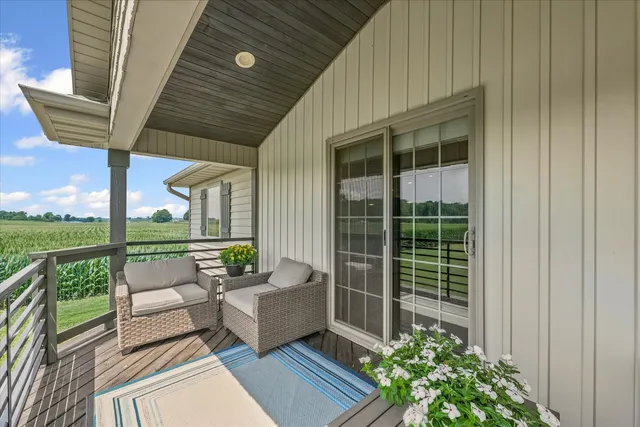 a balcony with furniture and a potted plant
