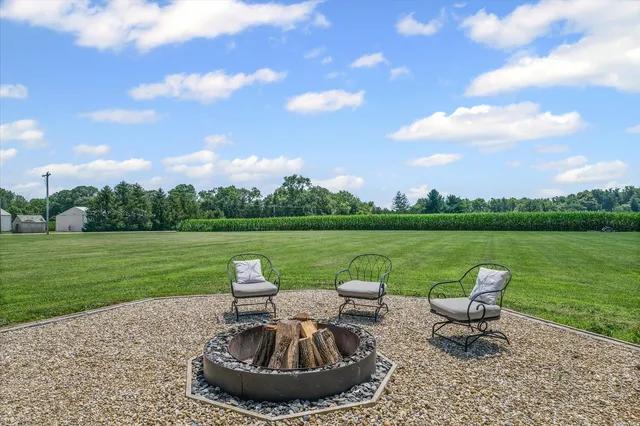 a view of a lake with a garden and outdoor seating