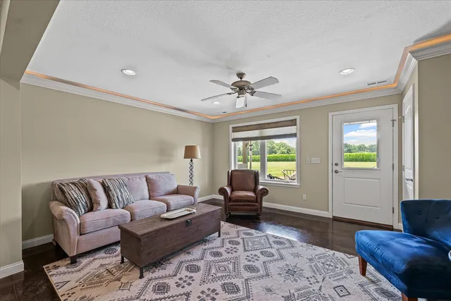 a living room with furniture and wooden floor
