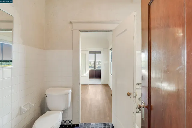 a view of hallway with a large window and wooden floor
