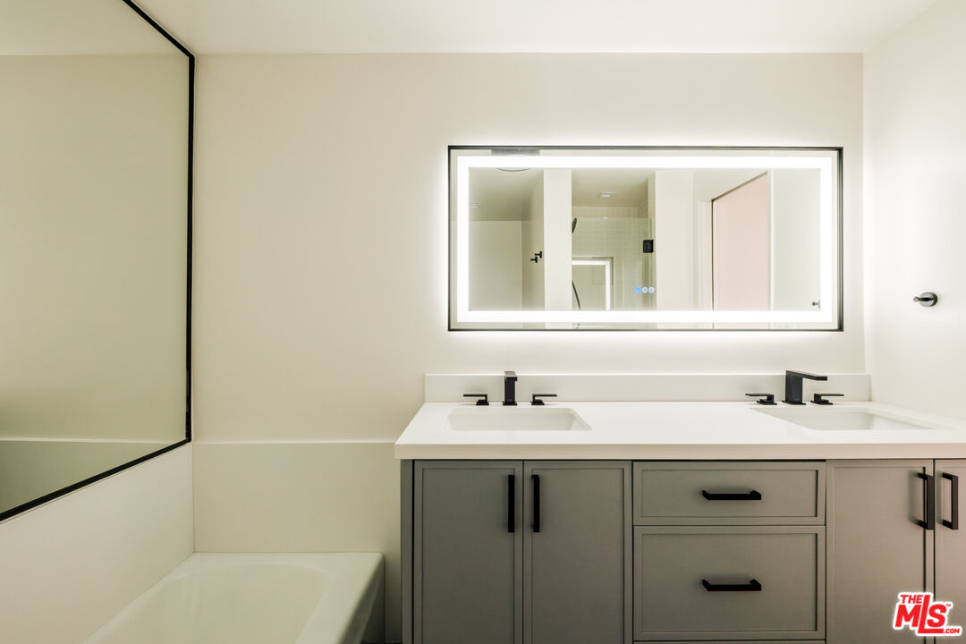 2160 Century Park, Unit 803 Los Angeles, CA 90067 - Photo 8 of 17 a bathroom with a sink and a mirror