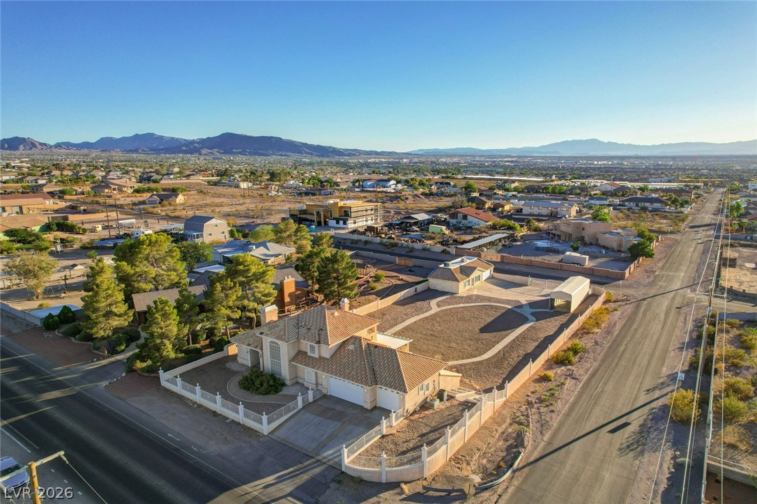 640 North Racetrack Road Henderson, NV 89015 - Photo 63 of 65 An aerial perspective reveals a spacious property with a desert landscape, offering panoramic views of distant mountains.