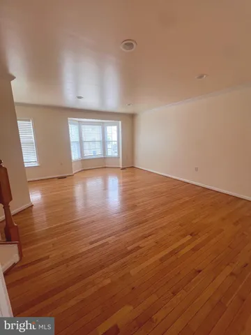 wooden floor in an empty room with window