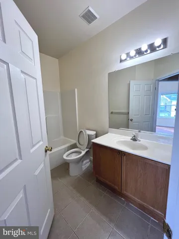 a bathroom with a sink toilet and a mirror