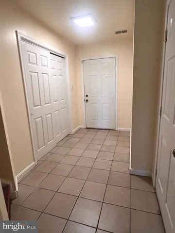 a view of a livingroom with an empty space and a window