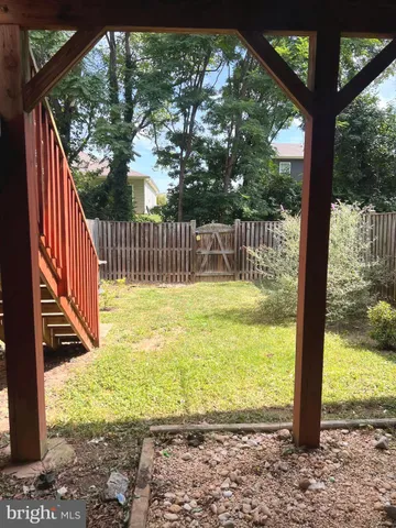 a view of a balcony with floor to ceiling windows and wooden fence