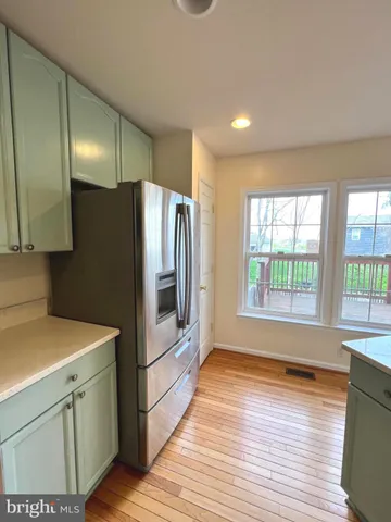 a kitchen with stainless steel appliances a refrigerator sink and cabinets