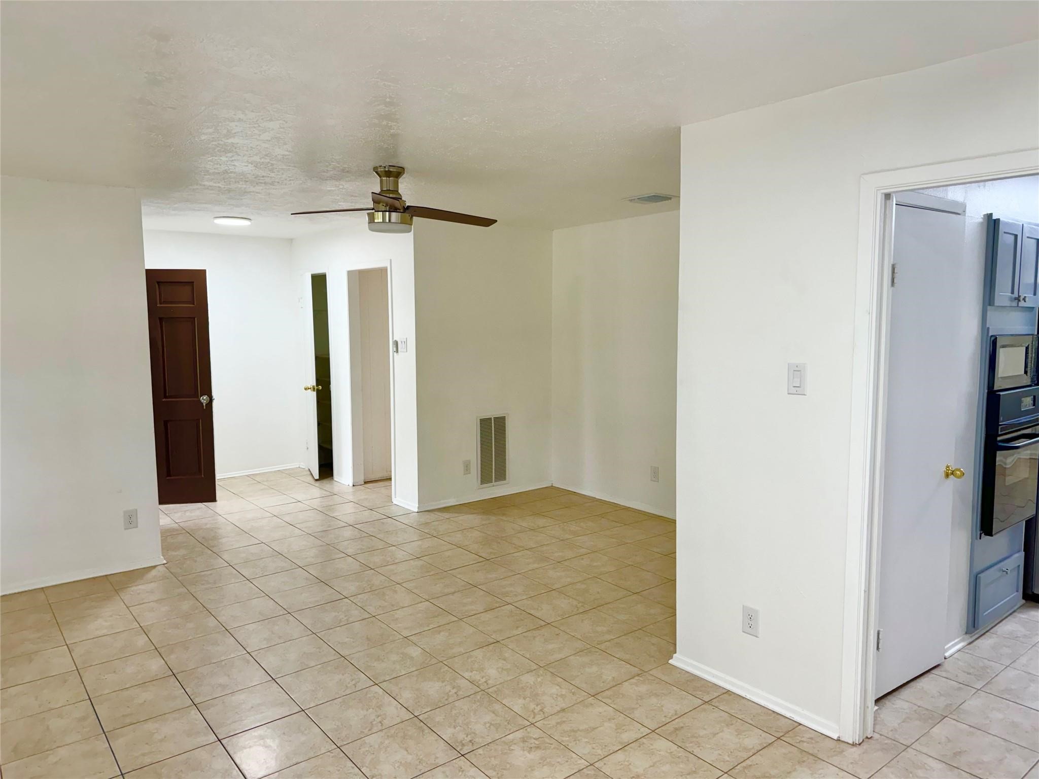 7015 Pyron Way Houston, TX 77036 - Photo 5 of 12 a view of a hallway with closet and a chandelier fan