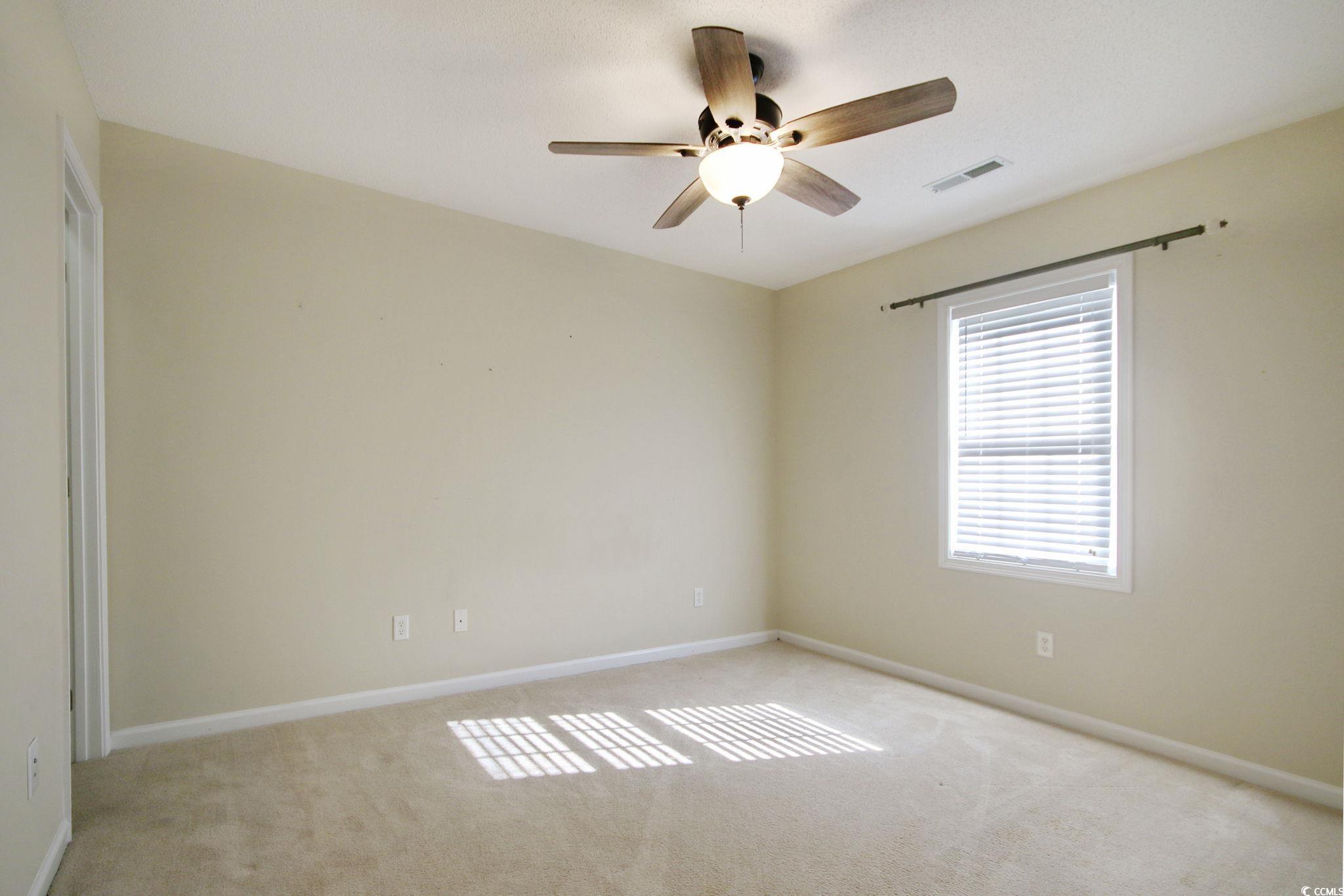 104 Osprey Cove Loop Myrtle Beach, SC 29588 - Photo 17 of 35 Carpeted empty room with ceiling fan