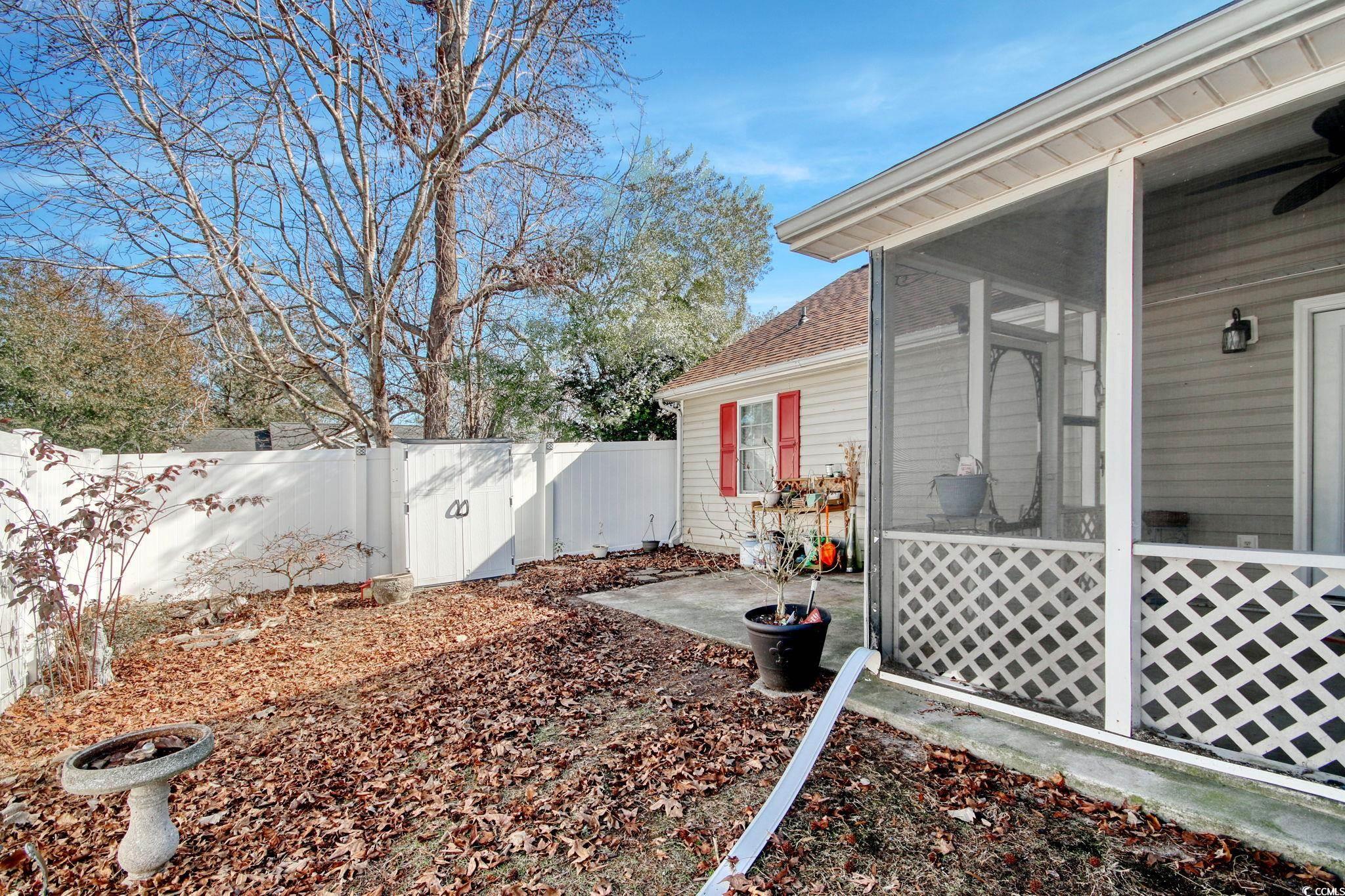 104 Osprey Cove Loop Myrtle Beach, SC 29588 - Photo 27 of 35 View of yard featuring ceiling fan, a sunroom, and