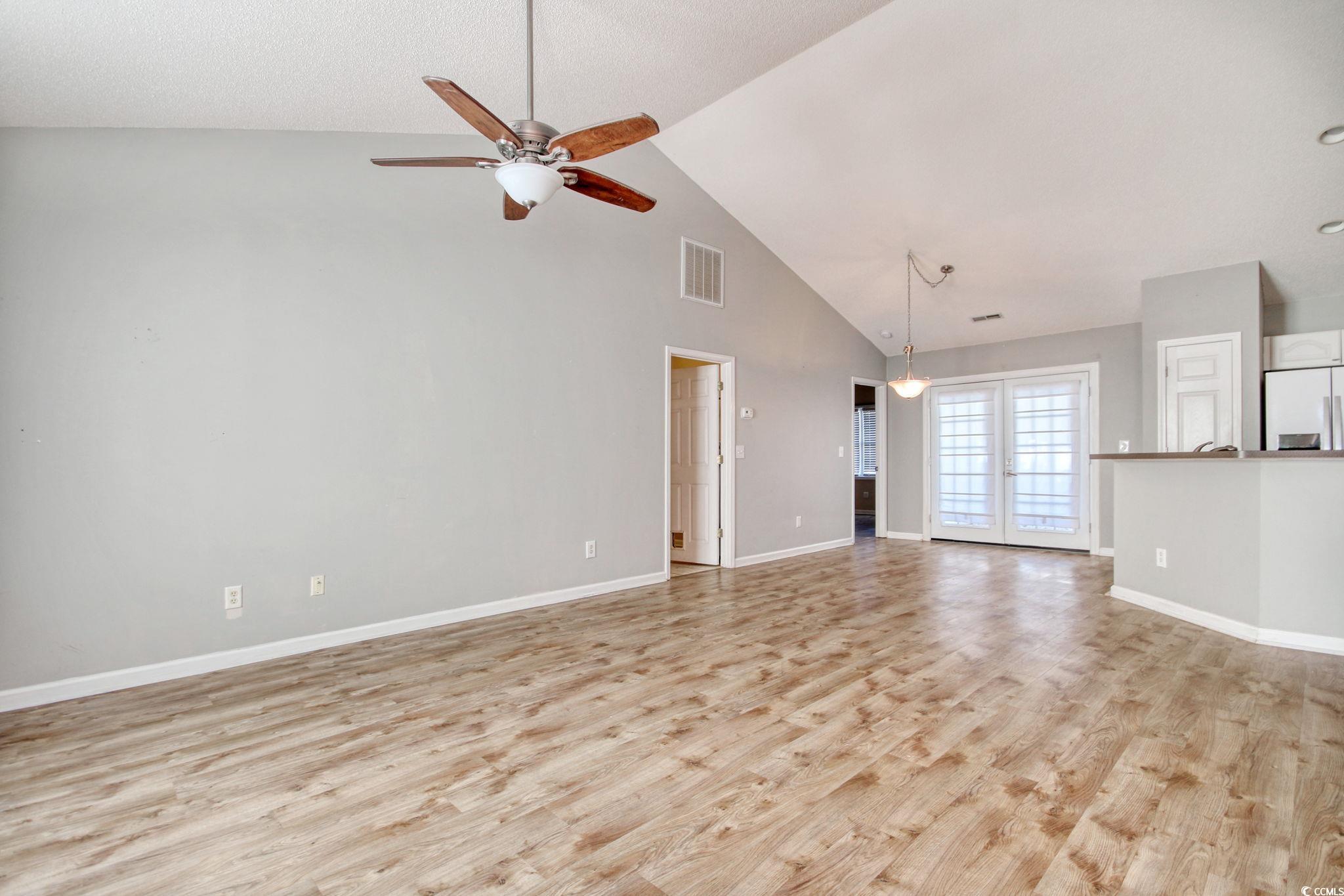 104 Osprey Cove Loop Myrtle Beach, SC 29588 - Photo 3 of 35 Unfurnished living room with ceiling fan, light ha