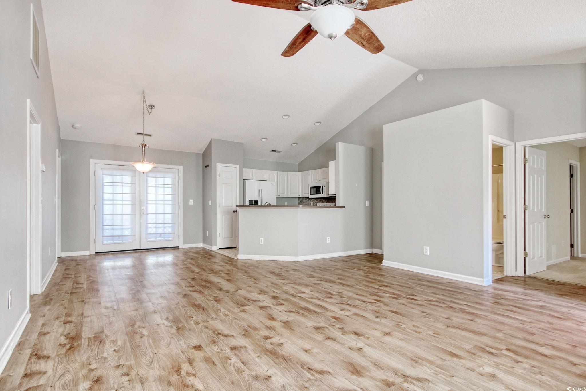 104 Osprey Cove Loop Myrtle Beach, SC 29588 - Photo 4 of 35 Unfurnished living room with ceiling fan, high vau