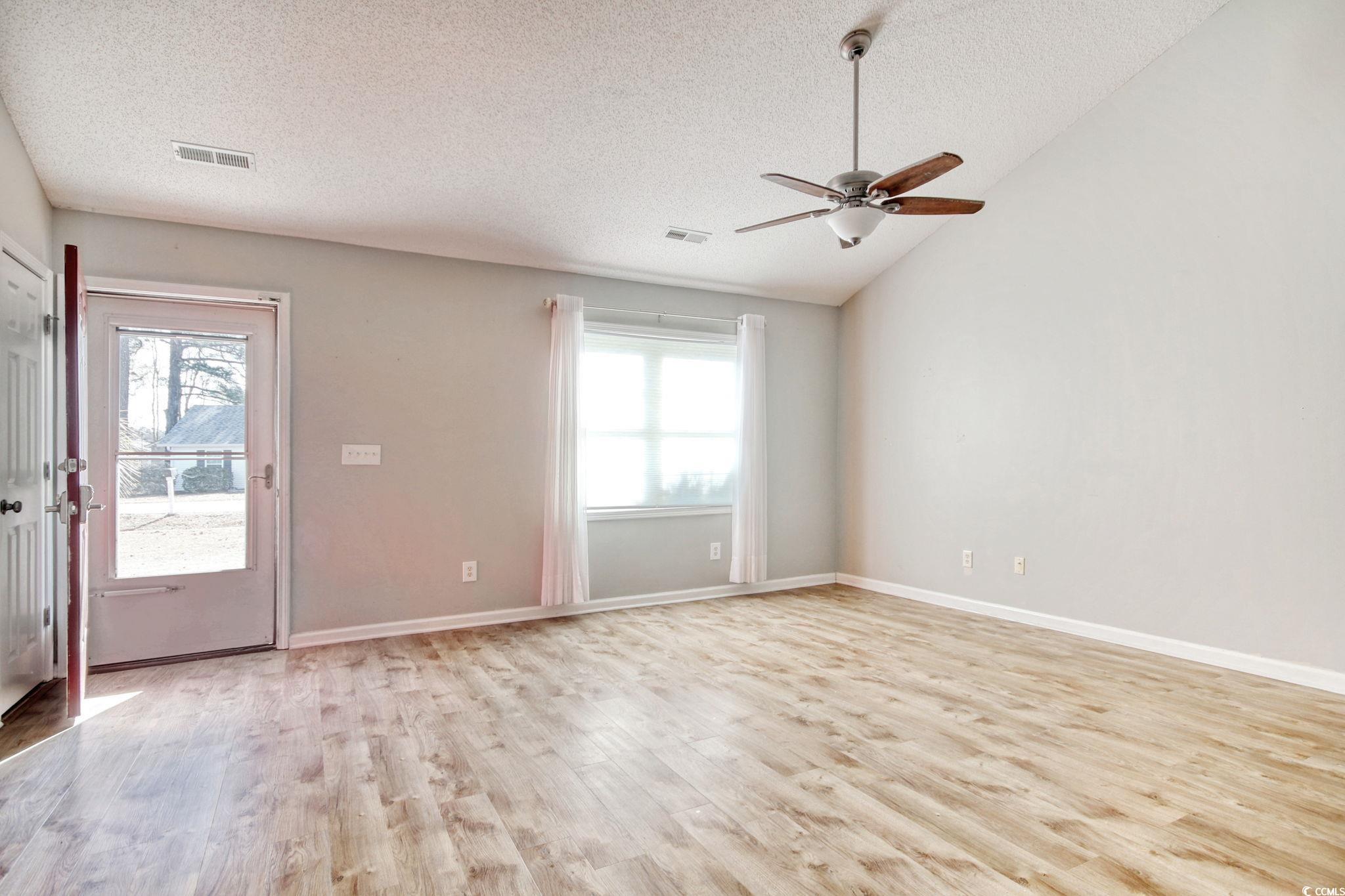104 Osprey Cove Loop Myrtle Beach, SC 29588 - Photo 5 of 35 Unfurnished room featuring lofted ceiling, a wealt