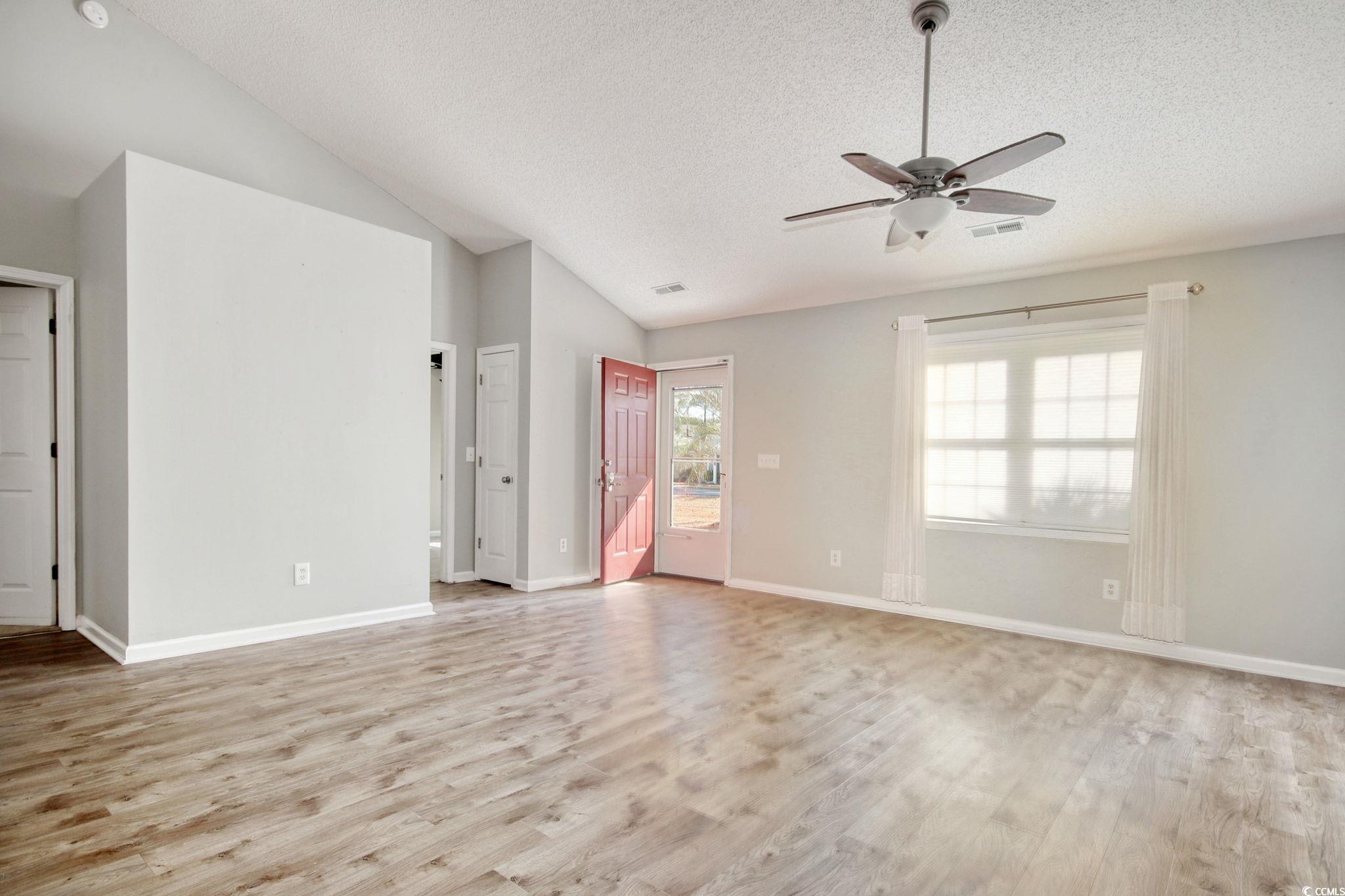 104 Osprey Cove Loop Myrtle Beach, SC 29588 - Photo 6 of 35 Empty room with lofted ceiling, ceiling fan, a tex