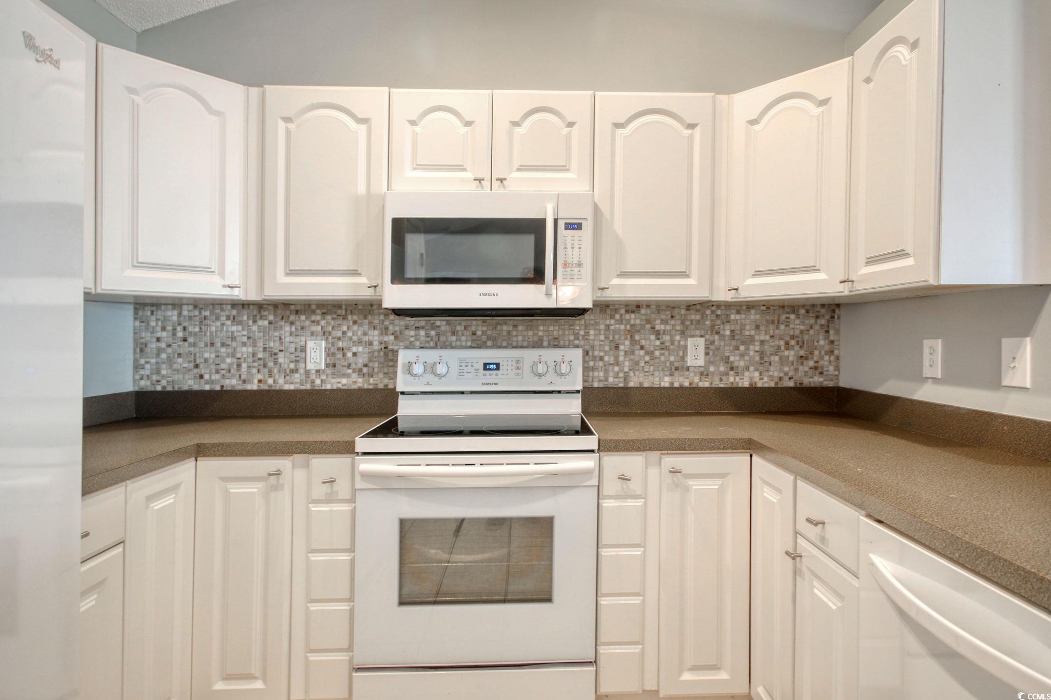 104 Osprey Cove Loop Myrtle Beach, SC 29588 - Photo 10 of 35 Kitchen featuring decorative backsplash, white cab
