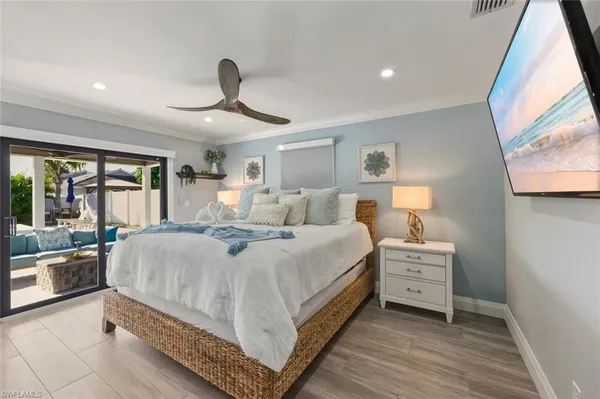 a large bedroom with a bed and large window