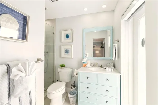 a bathroom with a sink vanity mirror and toilet