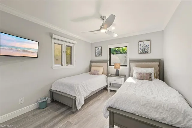 a bedroom with two beds and painting on the wall