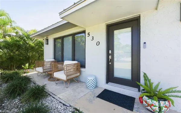 a bench sitting in front of a house